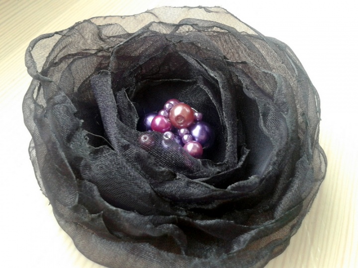 The eggplant-colored brooch