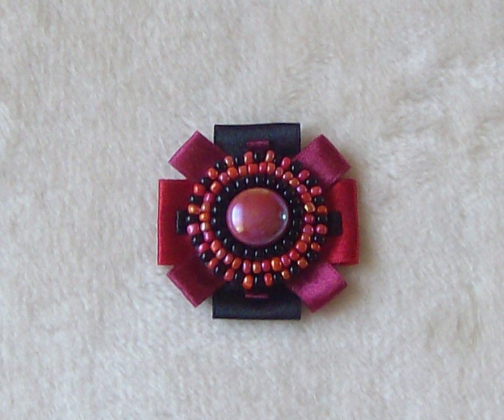 Burgundy-colored brooch